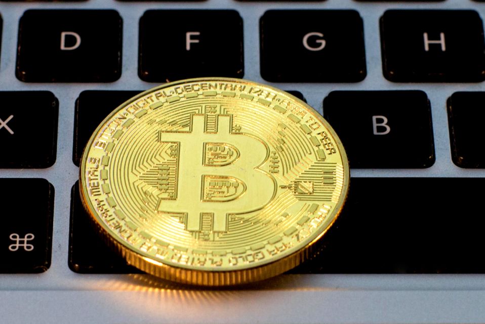 SPAIN - 2021/02/23: In this photo illustration, a Bitcoin is seen on the background of a computer keyboard. (Photo Illustration by Thiago Prudêncio/SOPA Images/LightRocket via Getty Images)